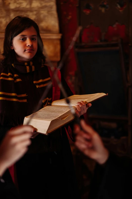 a girl reading an old book with her friends