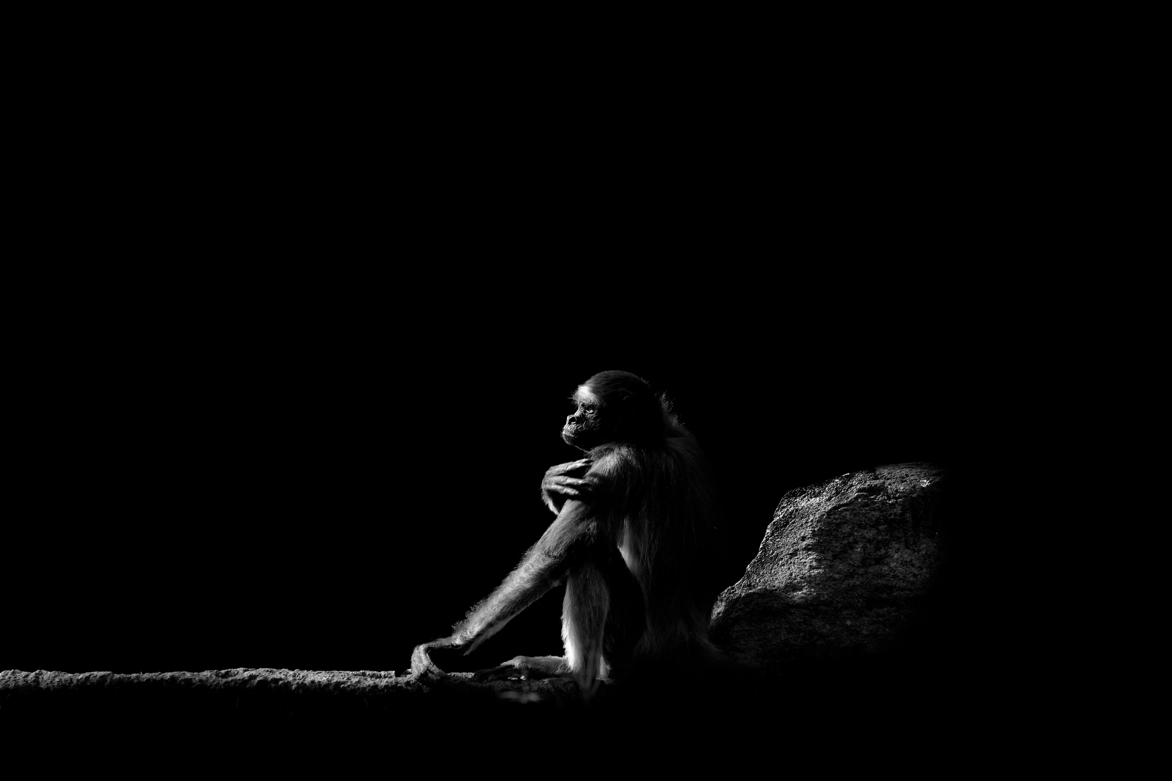 a man kneeling down with his hands clasped to his knee