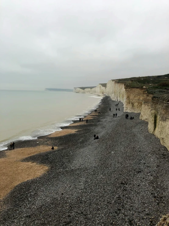 the beach is very rocky and has some black rocks to the side