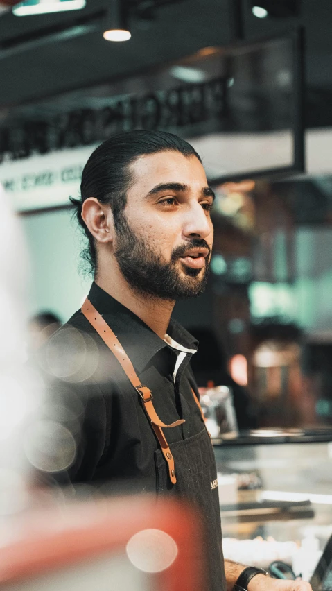 a man with long hair and beard wearing a brown shirt