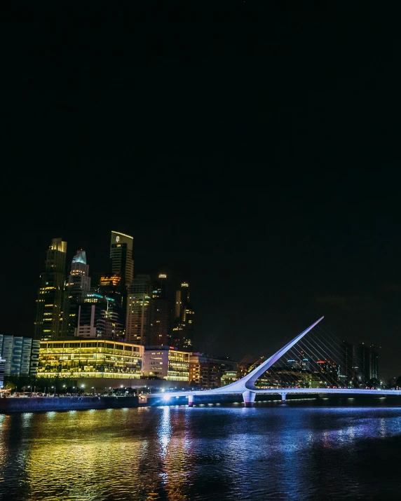 a night scene of a city and a bridge