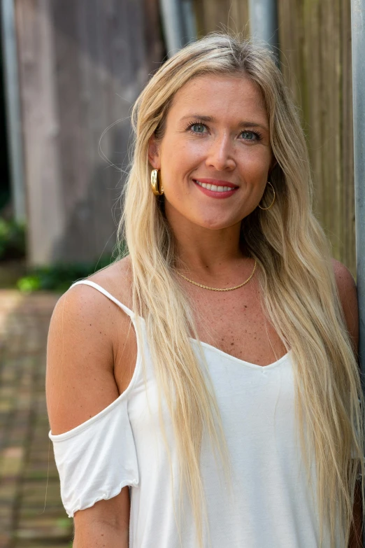 a woman with long hair smiling at the camera