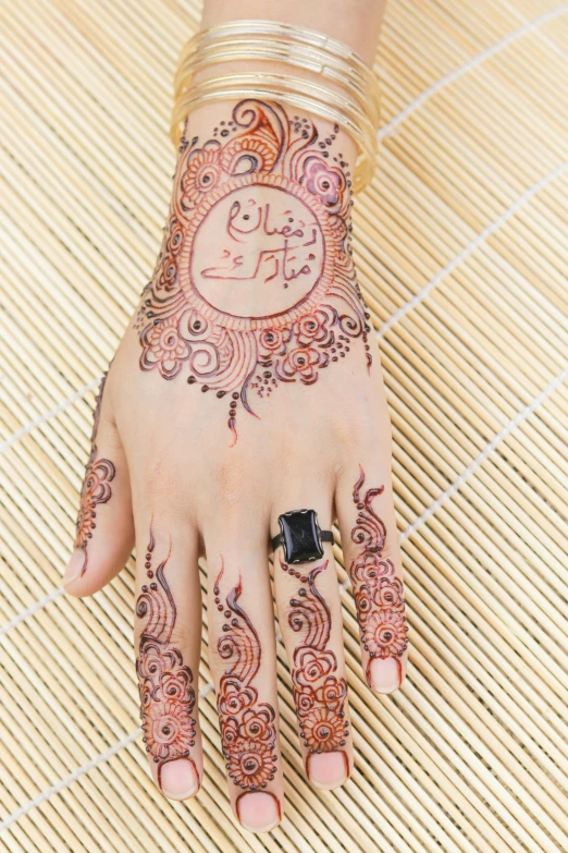 womans hand with henna and ring
