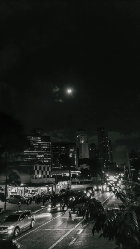 people crossing a city street at night