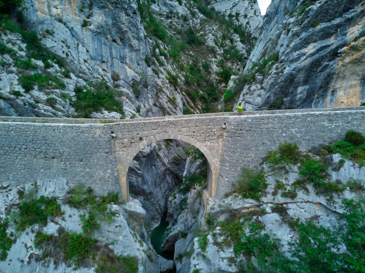 a bridge is built into a canyon side