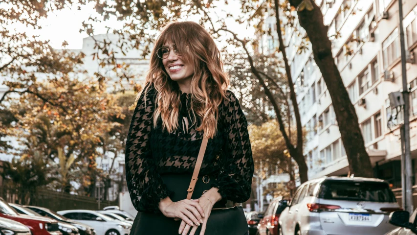 smiling woman in the city holding her purse