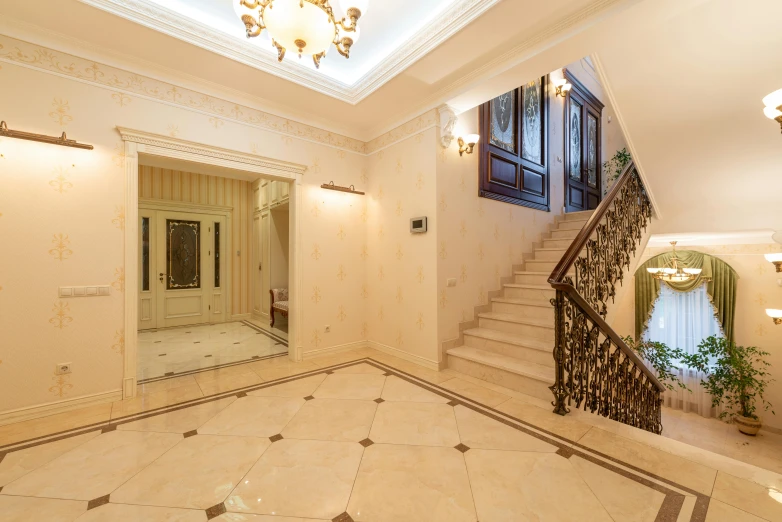 a white house with large tiled floors, fancy steps and a beautiful chandelier