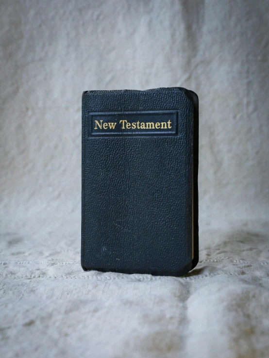 an old bible resting on a white cloth