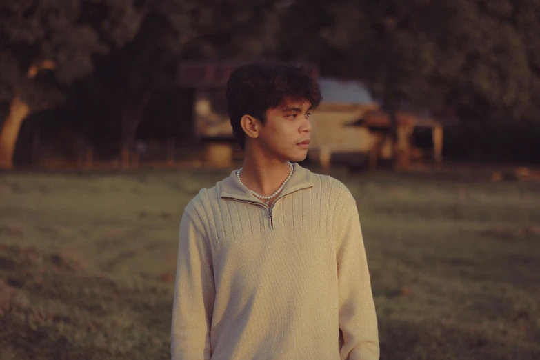 a boy is standing in an empty field