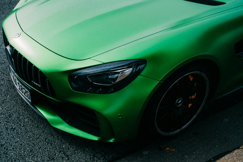 the green sports car parked on a city street