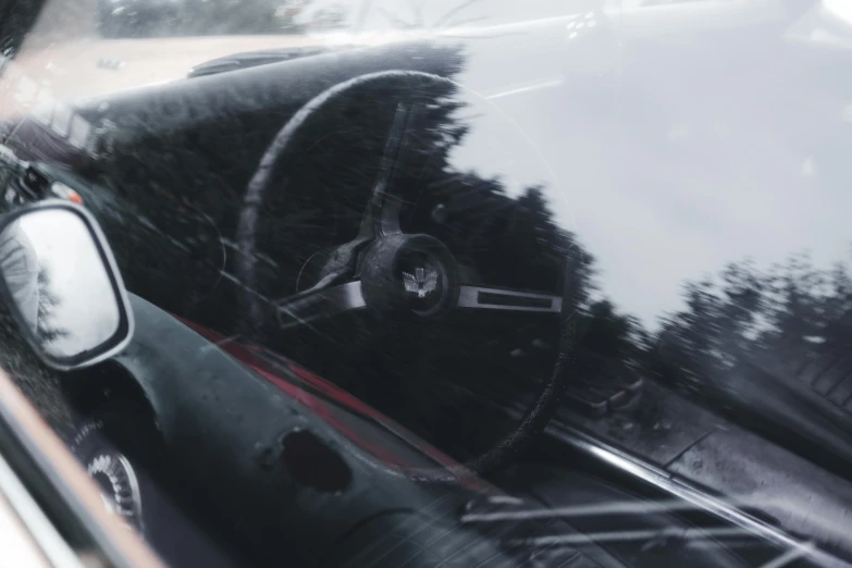 car dashboard with view of trees through windshield