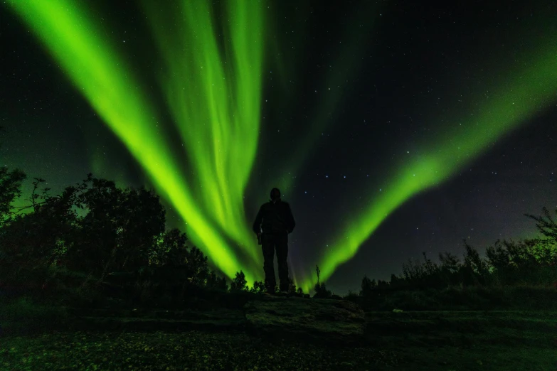 a man is looking at an impressive green light