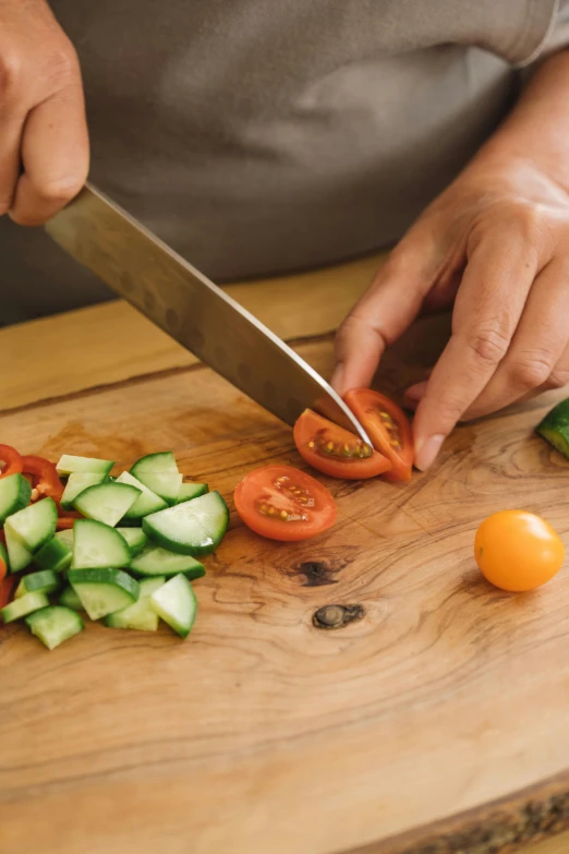 a person is chopping vegetables with a knife