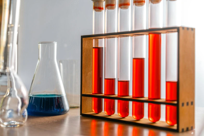 a shelf filled with red and blue test tubes