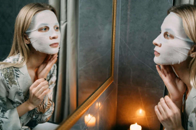 a woman with a white mask looking in the mirror