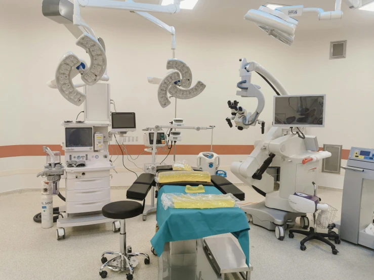 a medical room with equipment such as operating devices and microscopes