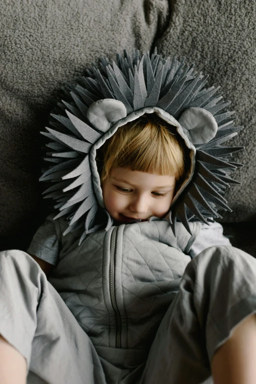 a small boy wearing a lion costume on a couch