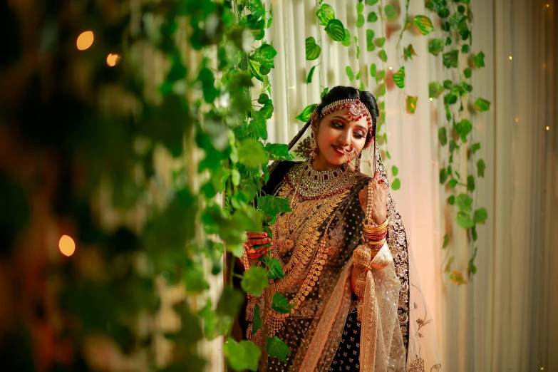 a woman dressed up in indian attire and with greenery