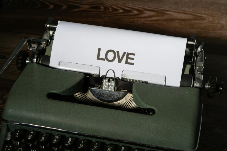 an old typewriter with love paper in it