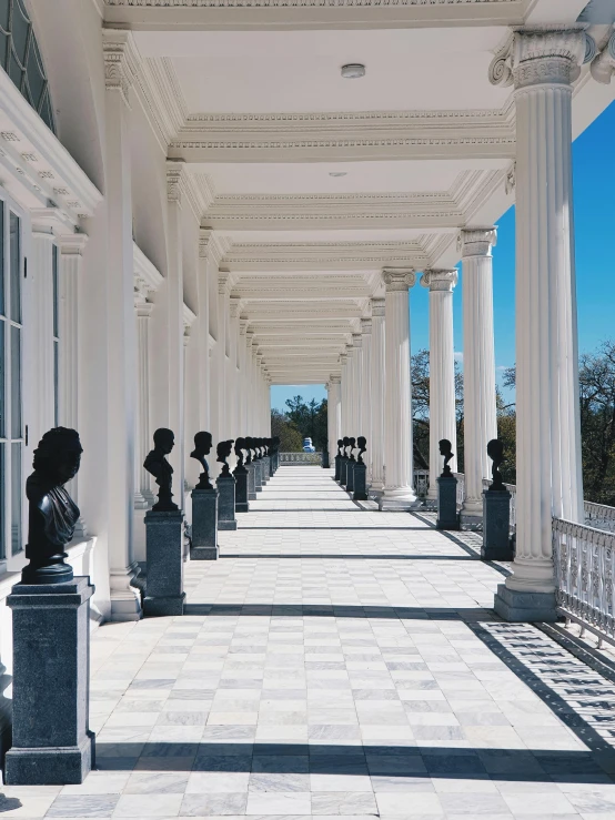 an elegant porch lined with columns and statues