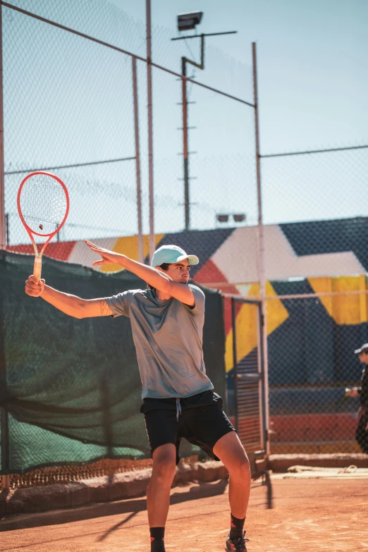 a man holding a tennis racquet on top of a tennis court