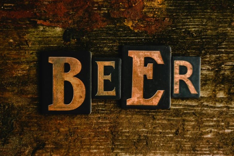 the word beer spelled in wood type type