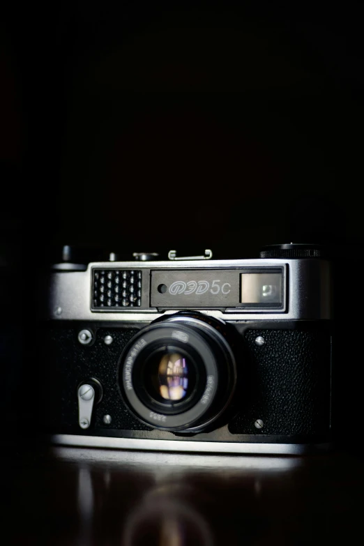 an old fashioned camera with no lens in the dark
