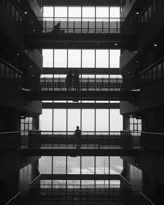 a tall building with many windows and a few people