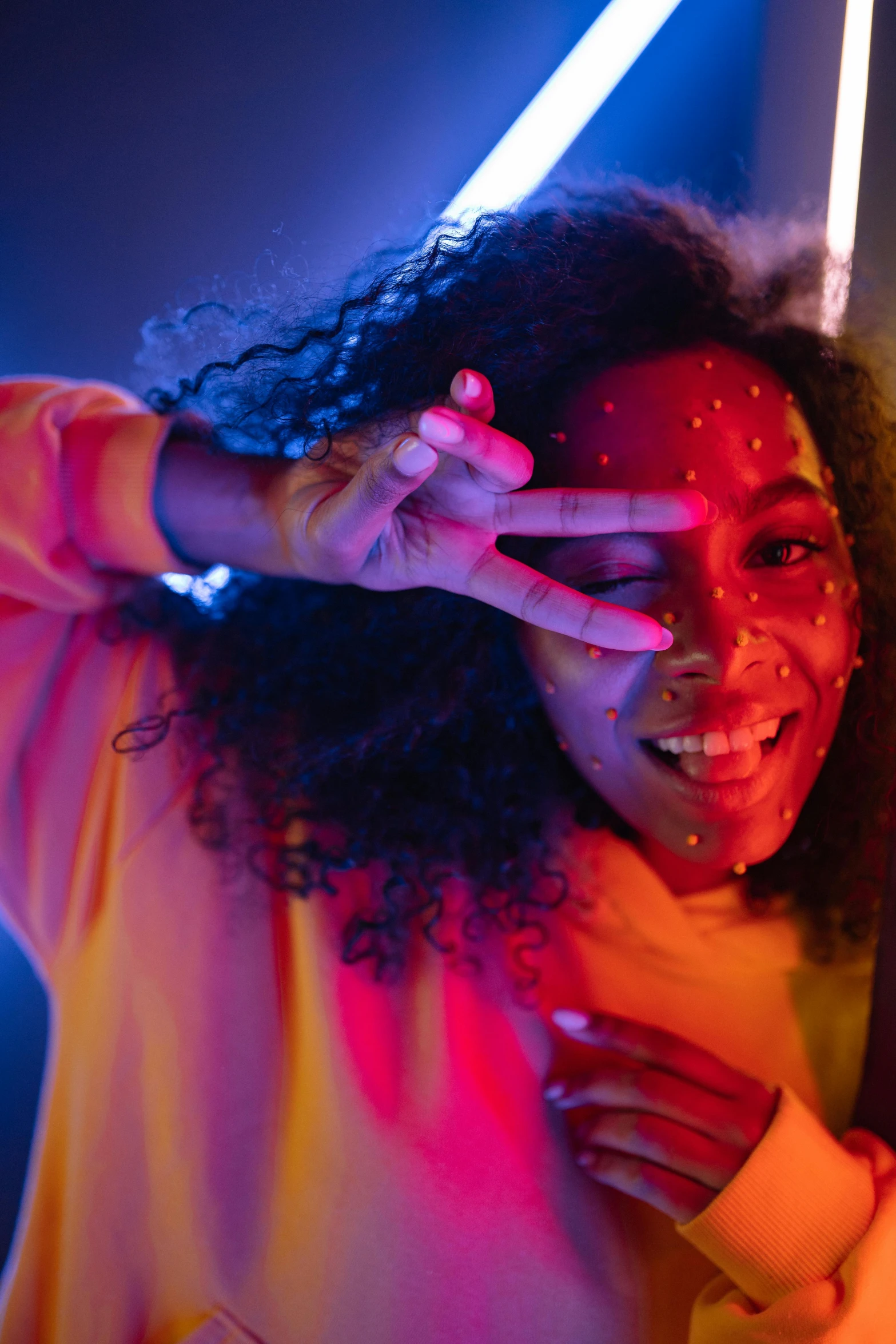 woman showing two hands with red and yellow flash paint