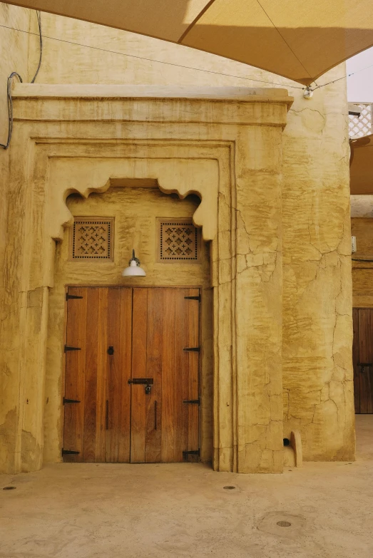 a couple of wood doors inside of a tan building