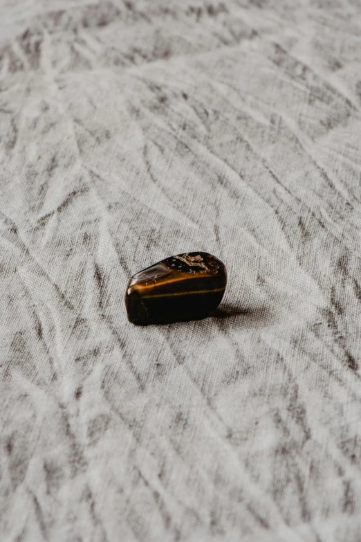 a cell phone laying on top of a white bed