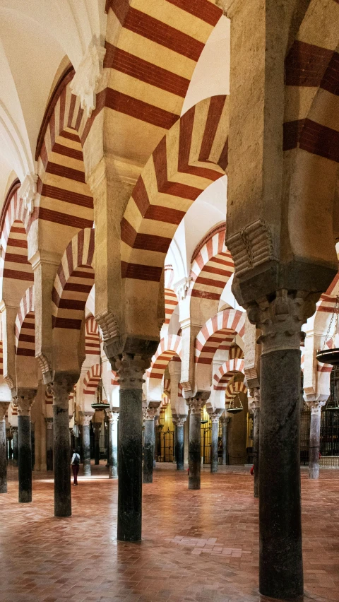 some arches and pillars in a large building