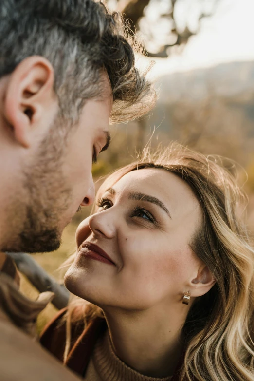 a beautiful blonde haired woman smiling with a man