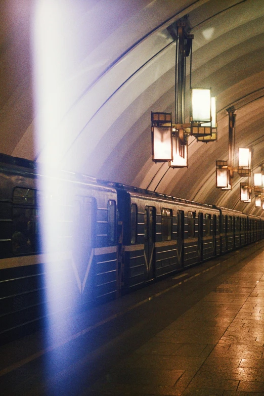 the subway has its lights on and is running fast