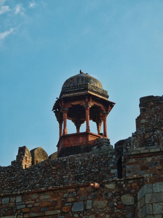 a tall building with a small roof on it