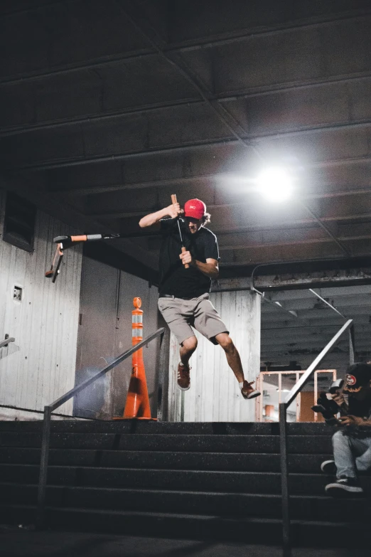 skateboarder jumping down and his board is off the stair railing