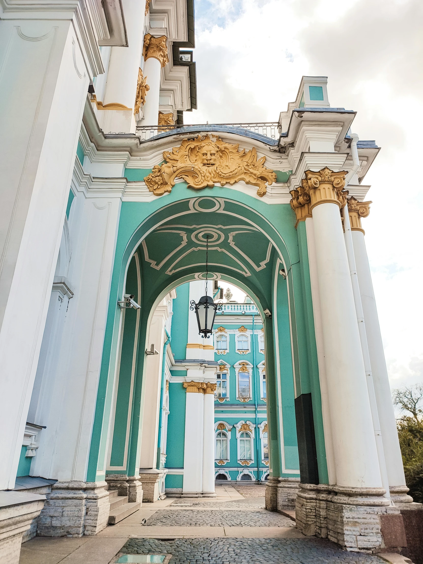 an archway and statue on the side of a building