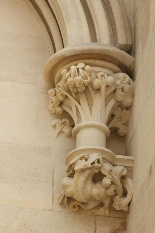 decorative gargon column above doorway, with carvings on the sides