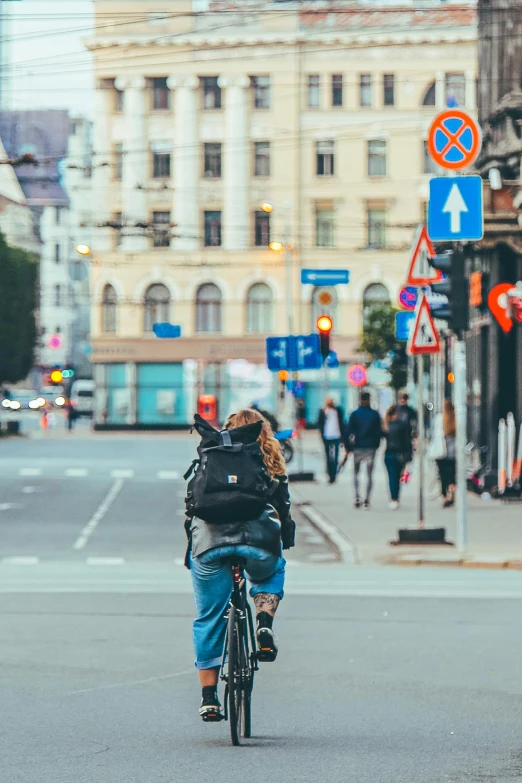 a man is riding his bike through the town