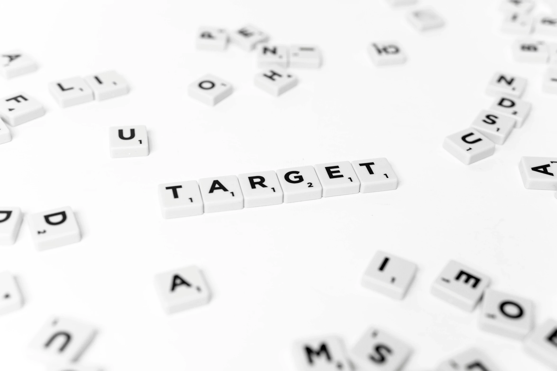 white blocks spelling the word target surrounded by word shaped tiles