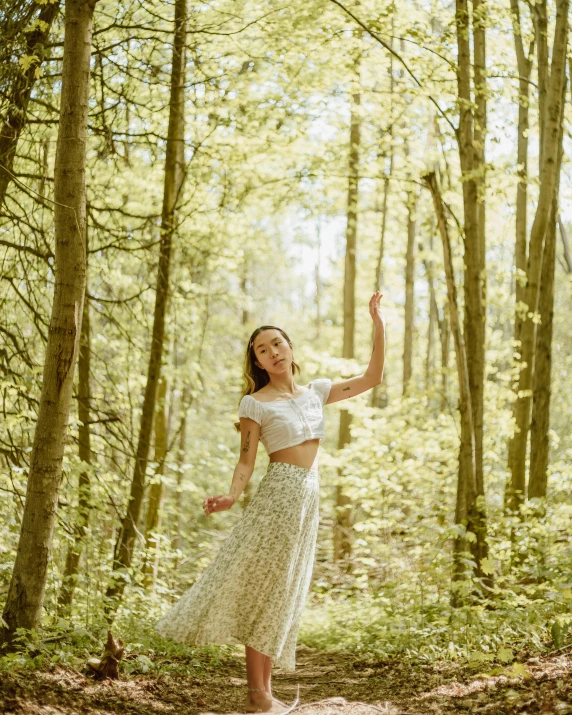 a woman in a dress poses for a po