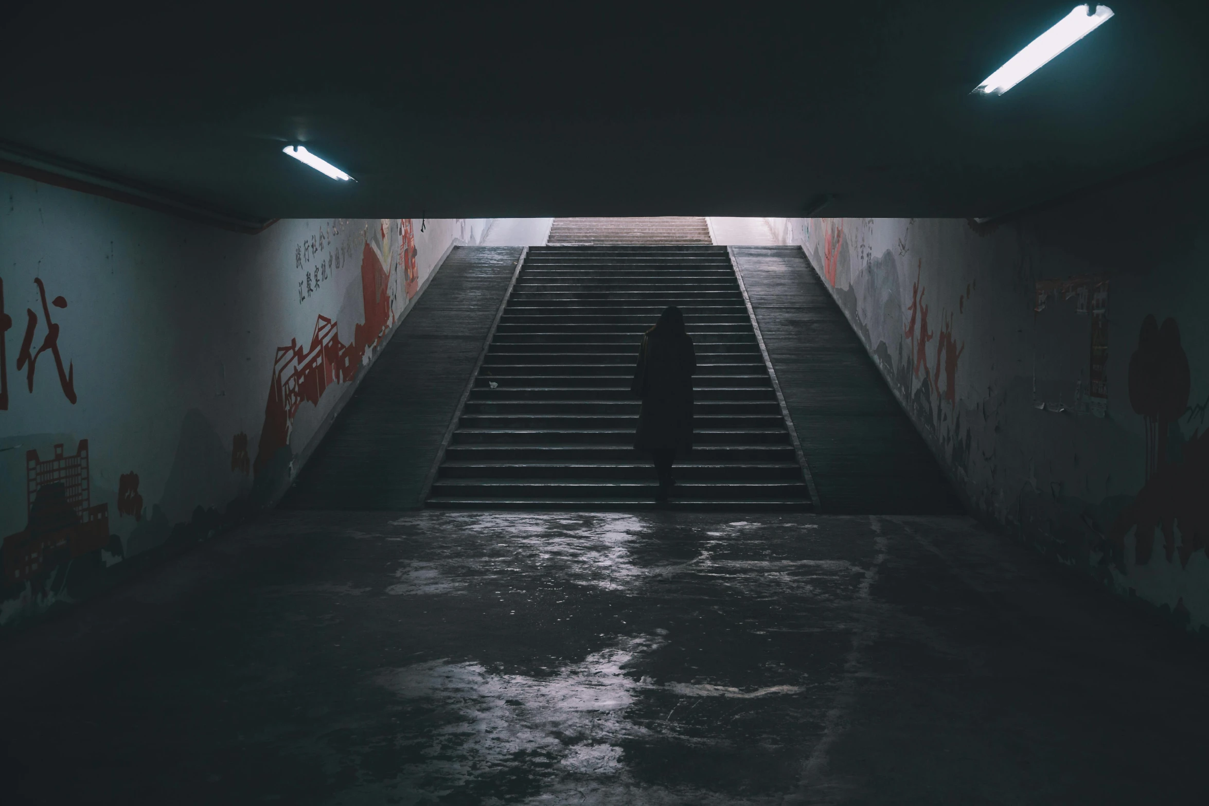 stairs leading up to another set of stairs in an area with graffiti on it