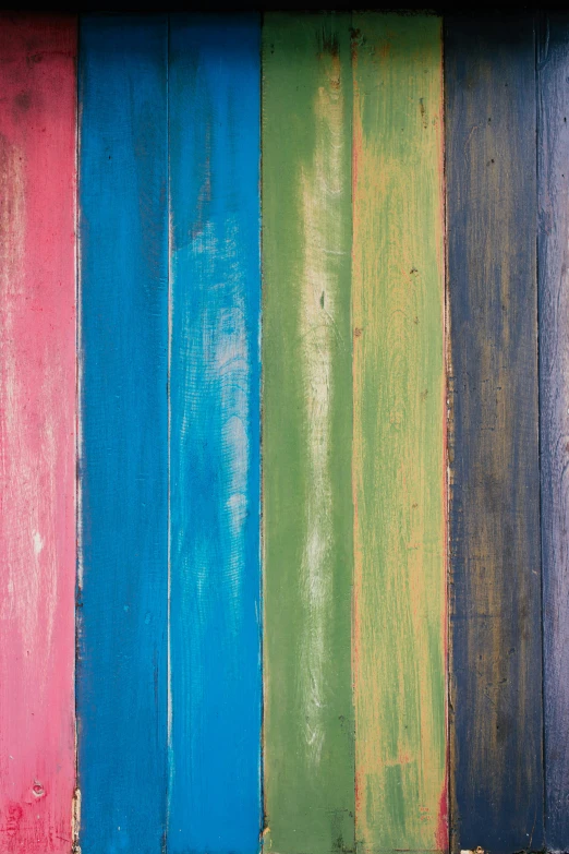 several colors are arranged in a wooden surface