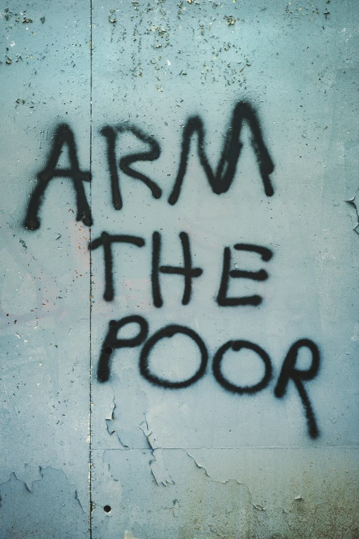 graffiti on the side of a building says arm the door