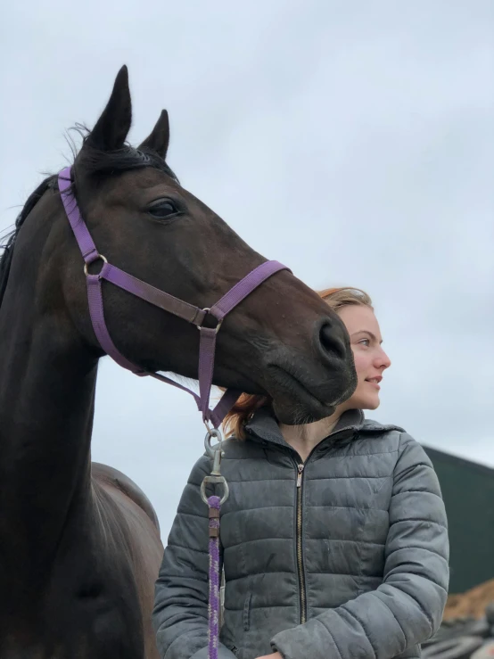 a woman with a horse in front of her