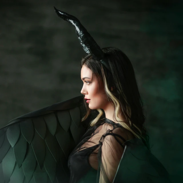 a woman in black with an angel wing