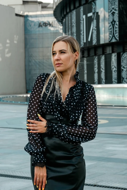 a woman with blonde hair standing in the street