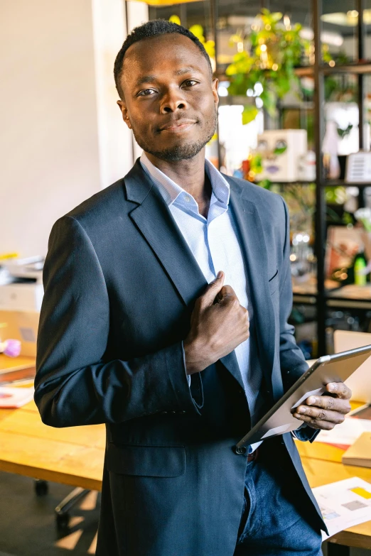 a young black man in suit and tie holding his hand on the clipboard