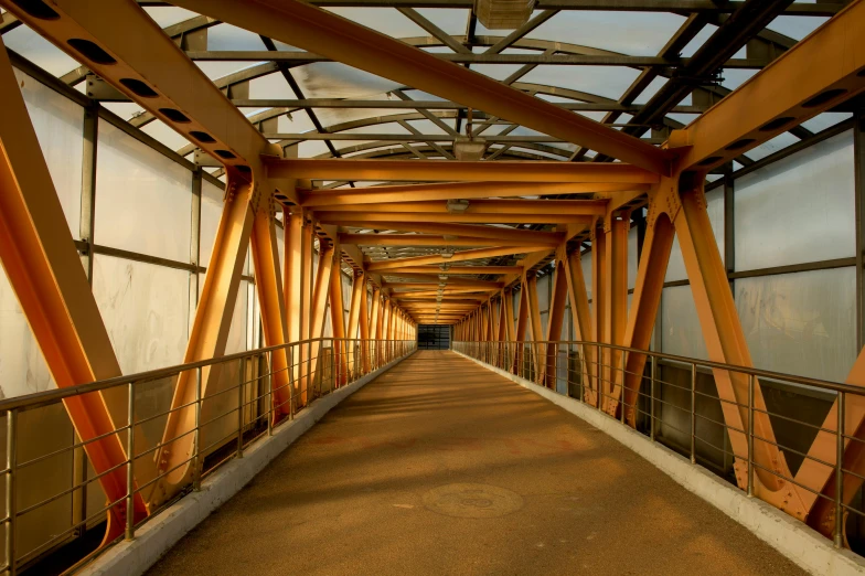 a walkway through a building with lots of glass