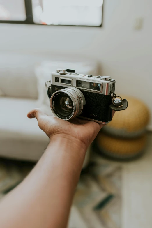 a small camera held in someone's hand